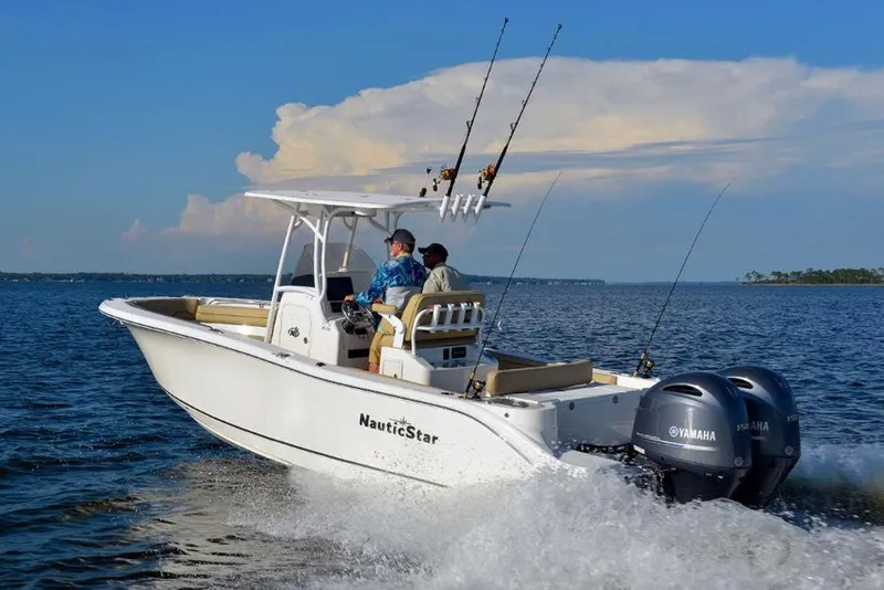 Slide: The Image of Manufacturer Provided Image: 2020 NauticStar 25 XS Offshore boat cruising on open water. - 2