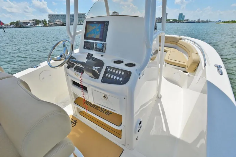Slide: The Image of Manufacturer Provided Image: 2020 NauticStar 25 XS Offshore boat interior with navigation system and steering wheel. - 9