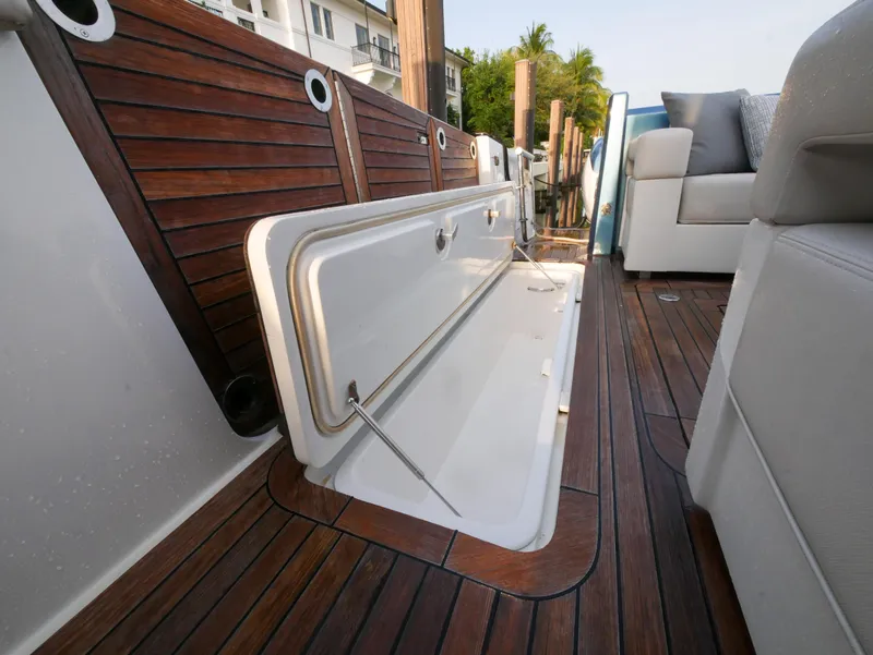 Slide: The Image of 2020 Ocean Alexander 45 Divergence Sport boat with open storage compartment on teak deck. - 14
