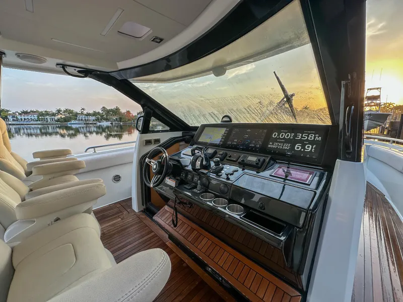 Slide: The Image of 2020 Ocean Alexander 45 Divergence Sport yacht cockpit with modern controls at sunset. - 16