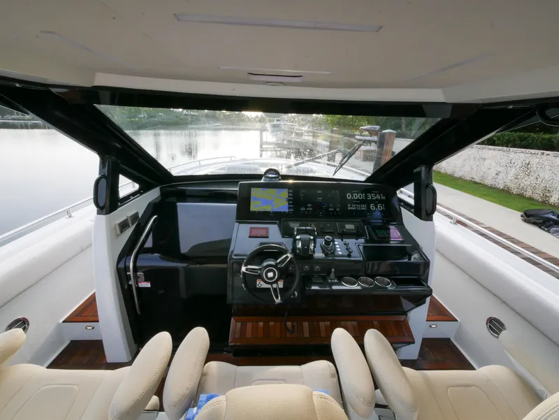 Slide: The Image of 2020 Ocean Alexander 45 Divergence Sport helm with modern controls and scenic waterway view. - 17