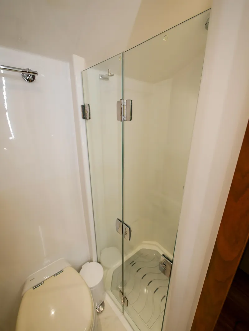 Slide: The Image of 2020 Ocean Alexander 45 Divergence Sport bathroom with glass shower and toilet. - 30
