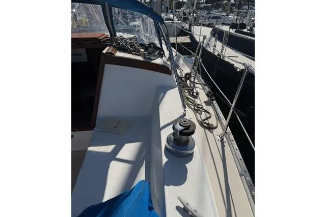 Slide: The Image of 1986 Catalina 36 sailboat deck with winch and rigging in marina. - 13