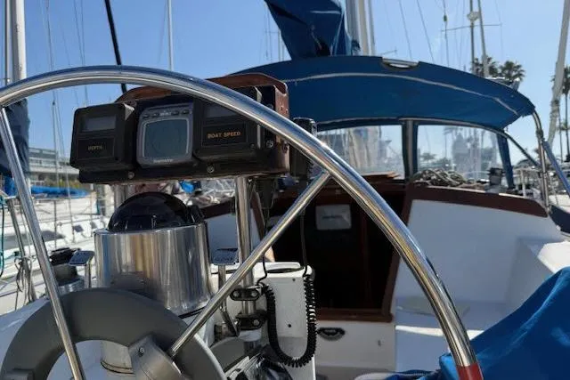 Slide: The Image of 1986 Catalina 36 sailboat cockpit with steering wheel and navigation instruments. - 14