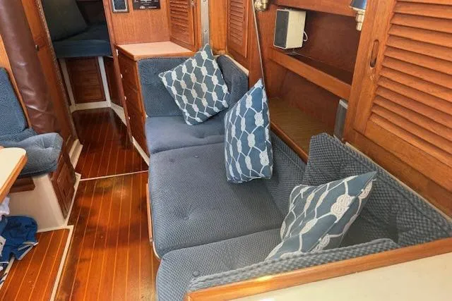 Slide: The Image of Interior of 1986 Catalina 36 sailboat with blue cushions and wooden accents. - 2