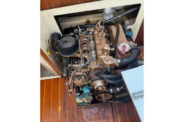 Slide: The Image of Engine compartment of a 1986 Catalina 36 sailboat, showcasing mechanical components. - 20