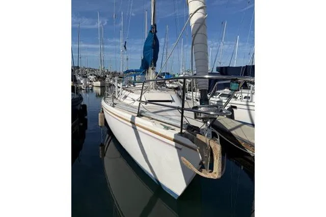 Slide: The Image of 1986 Catalina 36 sailboat docked in marina, clear sky, calm water. - 21