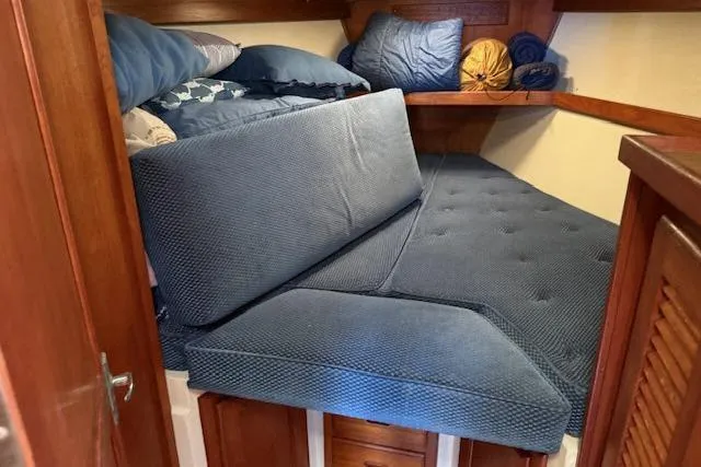 Slide: The Image of Cozy cabin interior of 1986 Catalina 36 sailboat with blue cushions and wooden accents. - 7