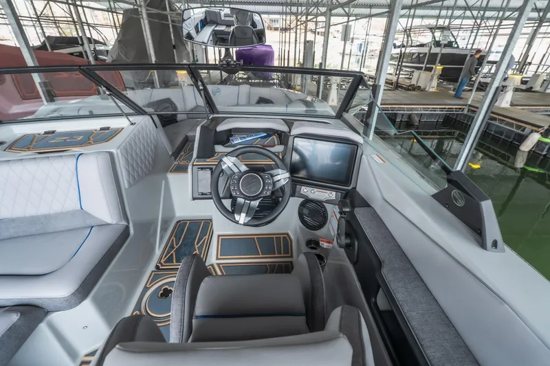 Slide: The Image of 2026 Tigé Z3 boat interior with modern dashboard and sleek design in marina setting. - 13