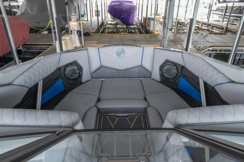 Slide: The Image of 2026 Tigé Z3 boat interior with luxurious seating and modern design in a docked setting. - 14