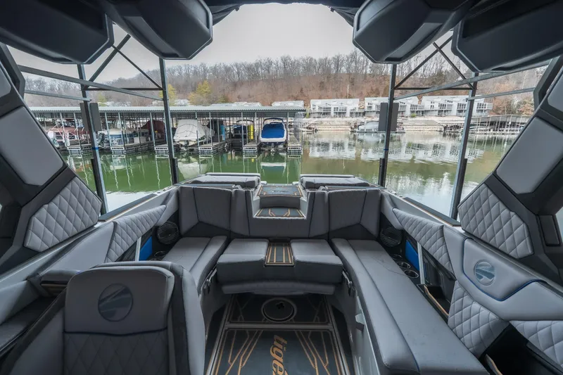 Slide: The Image of 2026 Tigé Z3 boat interior with luxurious seating, docked at a marina. - 17