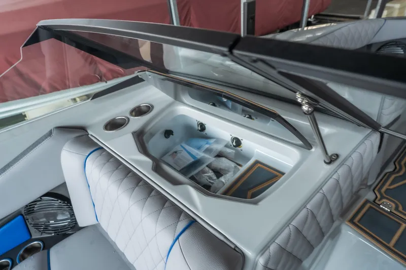 Slide: The Image of 2026 Tigé Z3 boat interior with open storage compartment and cup holders. - 18