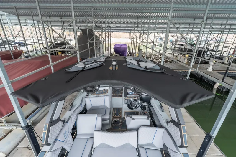 Slide: The Image of 2026 Tigé Z3 boat docked under a metal canopy, showcasing sleek design and modern features. - 26