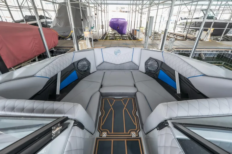 Slide: The Image of 2026 Tigé Z3 boat interior with luxurious seating and modern design in a marina setting. - 27