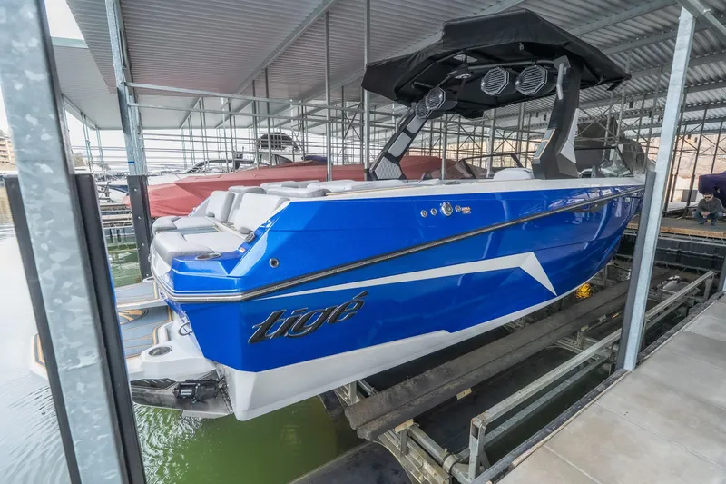 Slide: The Image of 2026 Tigé Z3 boat in blue, docked in a covered marina. - 3