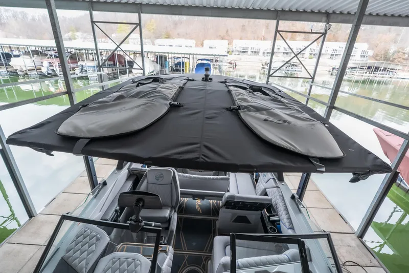 Slide: The Image of 2026 Tigé Z3 boat with covered top, docked in a marina setting. - 30