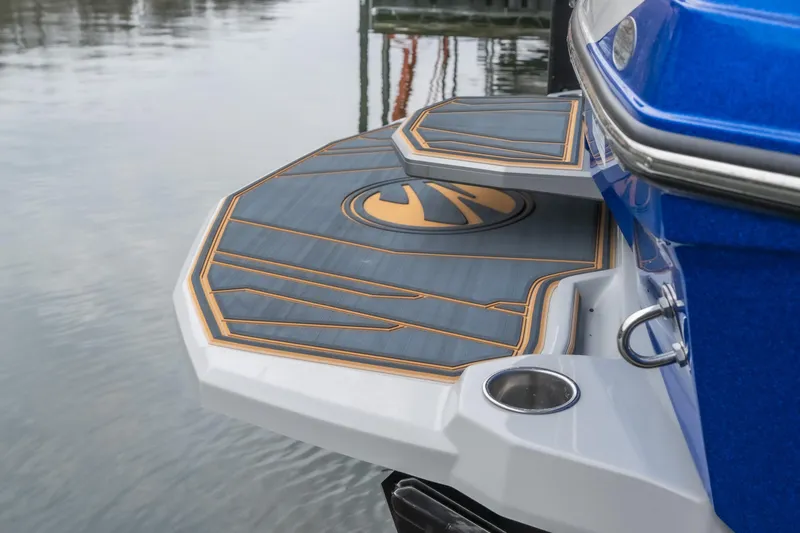 Slide: The Image of 2026 Tigé Z3 boat swim platform with stylish design and logo, docked on calm water. - 4