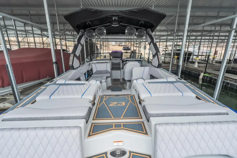 Slide: The Image of 2026 Tigé Z3 boat interior with luxurious seating and modern design in a marina setting. - 8