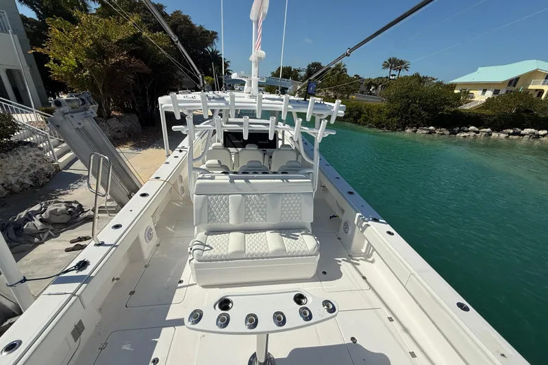 Slide: The Image of 2023 Invincible 46 Catamaran docked, showcasing spacious deck and seating area. - 17