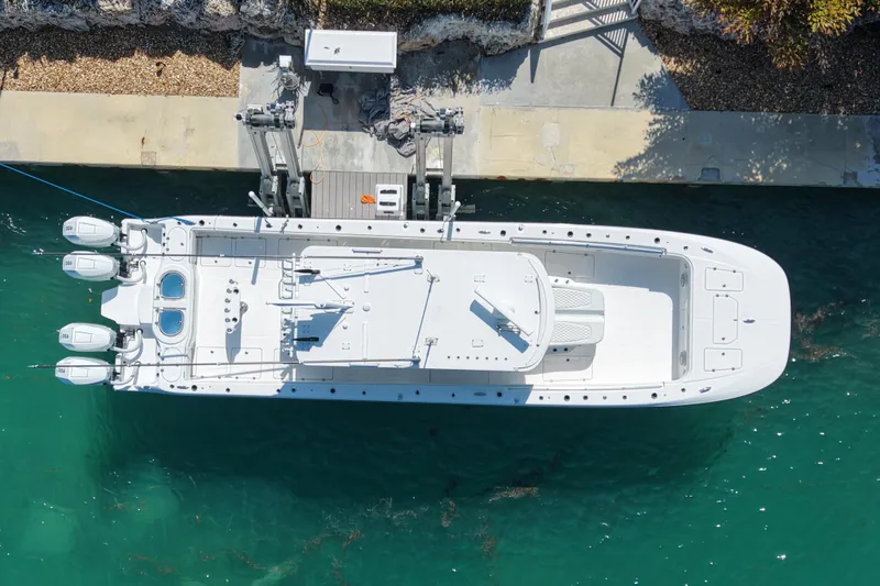 Slide: The Image of Aerial view of 2023 Invincible 46 Catamaran docked in clear turquoise water. - 2