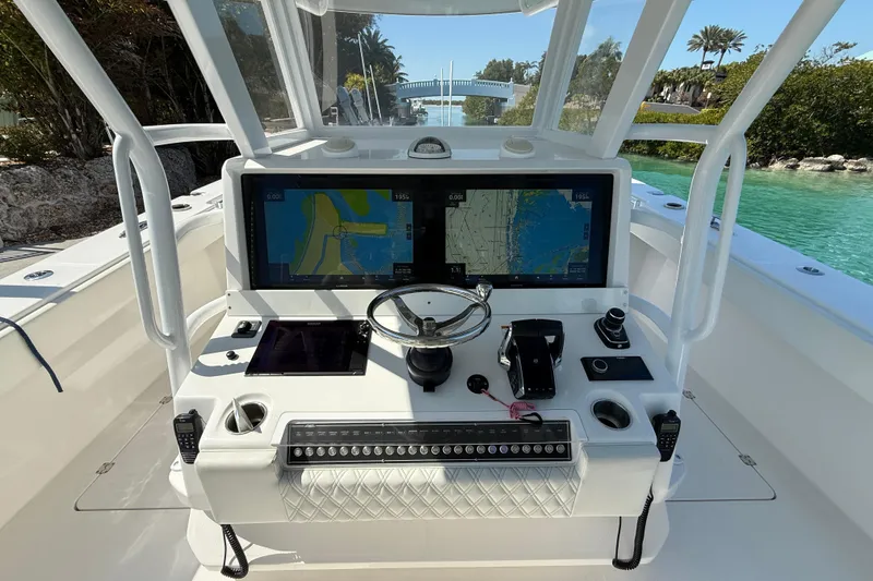 Slide: The Image of Cockpit of 2023 Invincible 46 Catamaran with navigation screens and steering wheel. - 21
