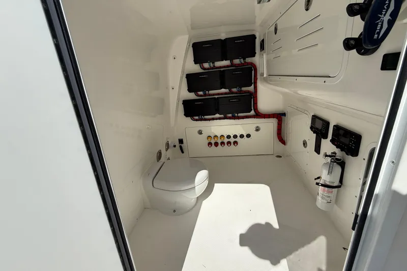 Slide: The Image of 2023 Invincible 46 Catamaran interior with toilet, control panels, and fire extinguisher. - 22