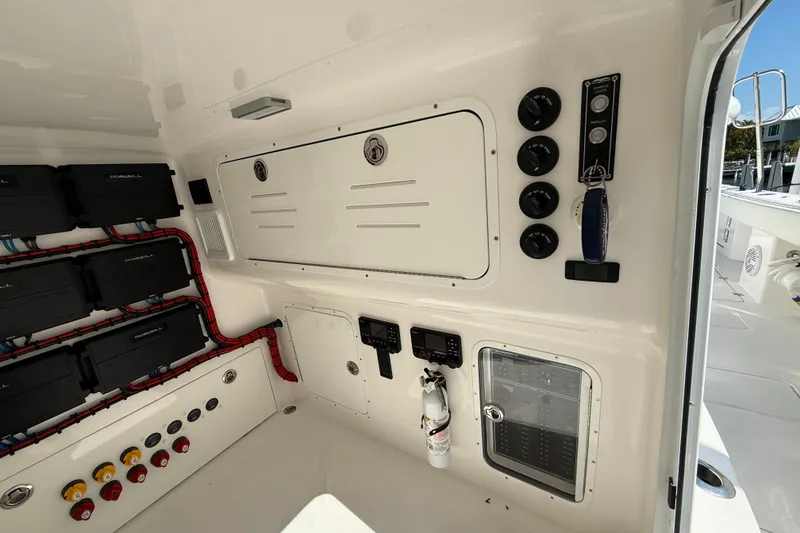 Slide: The Image of 2023 Invincible 46 Catamaran electrical panel with controls and wiring. - 23