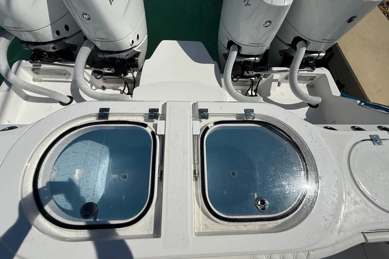 Slide: The Image of 2023 Invincible 46 Catamaran with dual livewells and powerful outboard engines. - 25