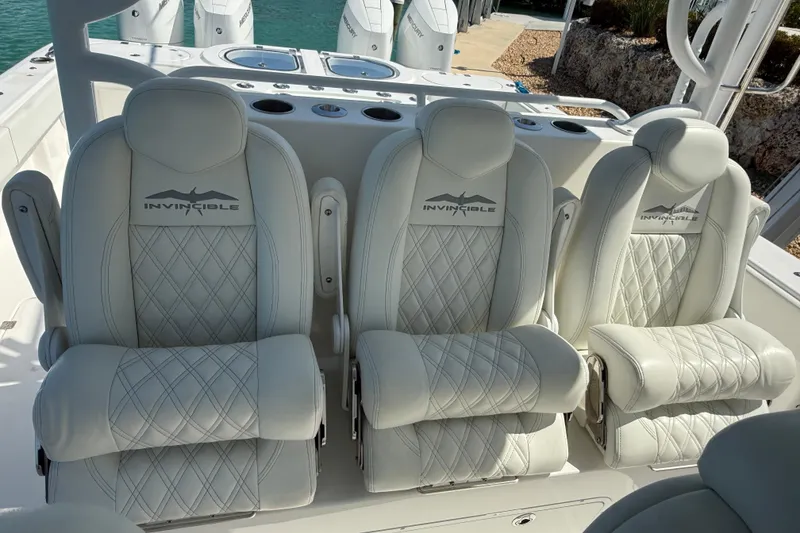 Slide: The Image of Luxurious seating on 2023 Invincible 46 Catamaran, featuring diamond-stitched white upholstery. - 27