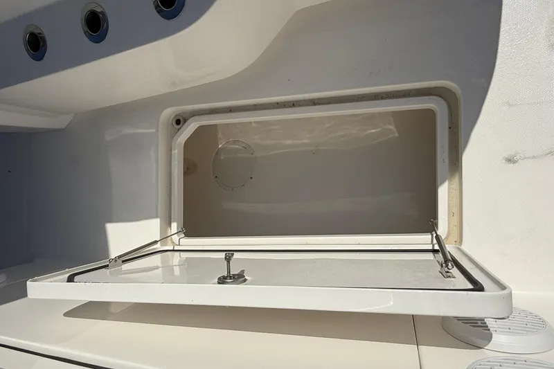 Slide: The Image of Open storage compartment on 2023 Invincible 46 Catamaran, showcasing interior space. - 33