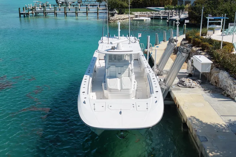 Slide: The Image of 2023 Invincible 46 Catamaran docked in clear turquoise water, showcasing sleek design. - 5