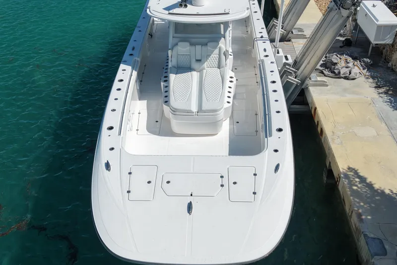 Slide: The Image of 2023 Invincible 46 Catamaran docked, showcasing sleek design and spacious deck layout. - 8