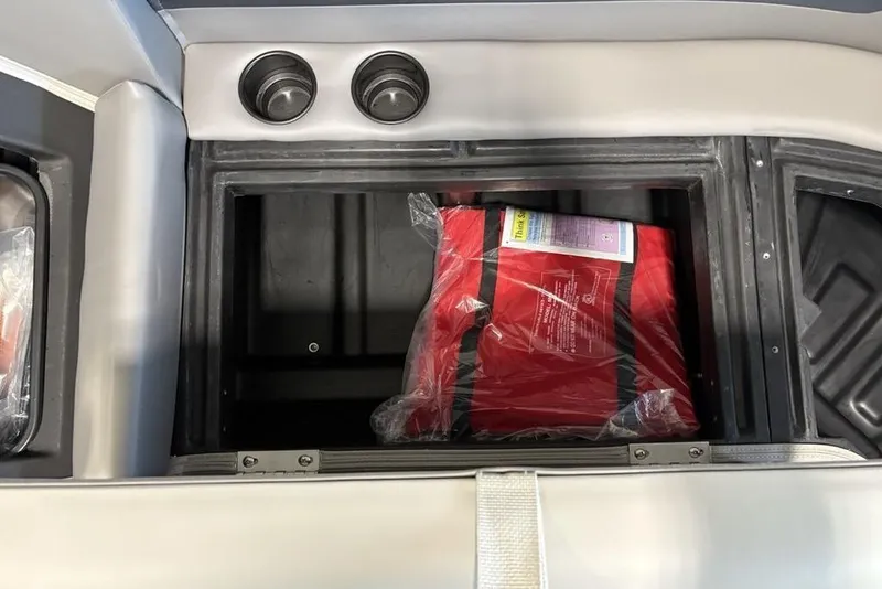 Slide: The Image of Storage compartment in 2026 Premier 220 Sunscape RL - CL with red life jacket. - 10