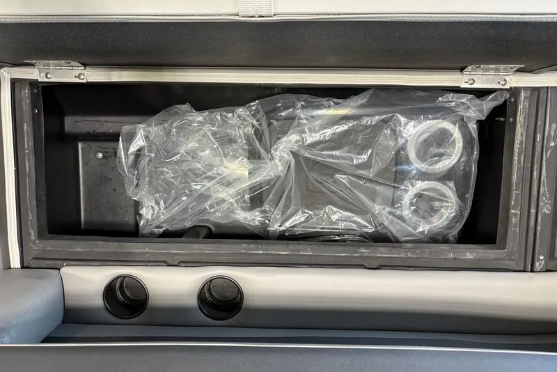 Slide: The Image of Storage compartment in 2026 Premier 220 Sunscape RL - CL boat, featuring wrapped components. - 4