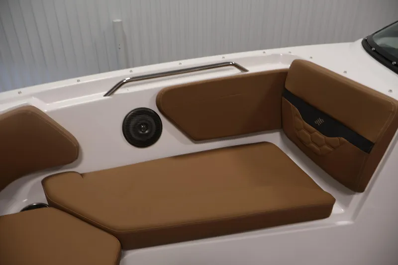 Slide: The Image of 2026 Four Winns HD2 OB boat interior with brown cushioned seating and speaker. - 17
