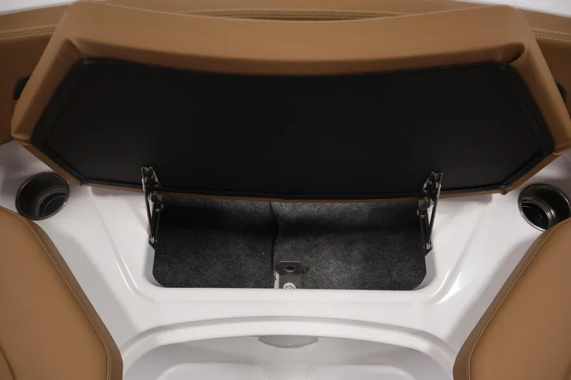 Slide: The Image of 2026 Four Winns HD2 OB boat storage compartment with tan seating and cup holders. - 19