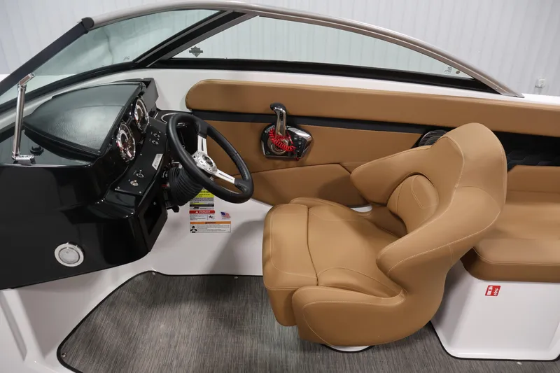 Slide: The Image of 2026 Four Winns HD2 OB boat interior with tan seating and modern dashboard controls. - 20