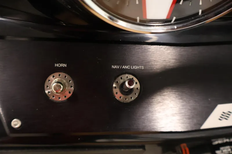Slide: The Image of Control panel of 2026 Four Winns HD2 OB boat with horn and navigation lights switches. - 24