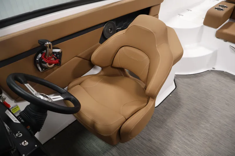 Slide: The Image of 2026 Four Winns HD2 OB boat interior with tan captain's seat and steering wheel. - 27