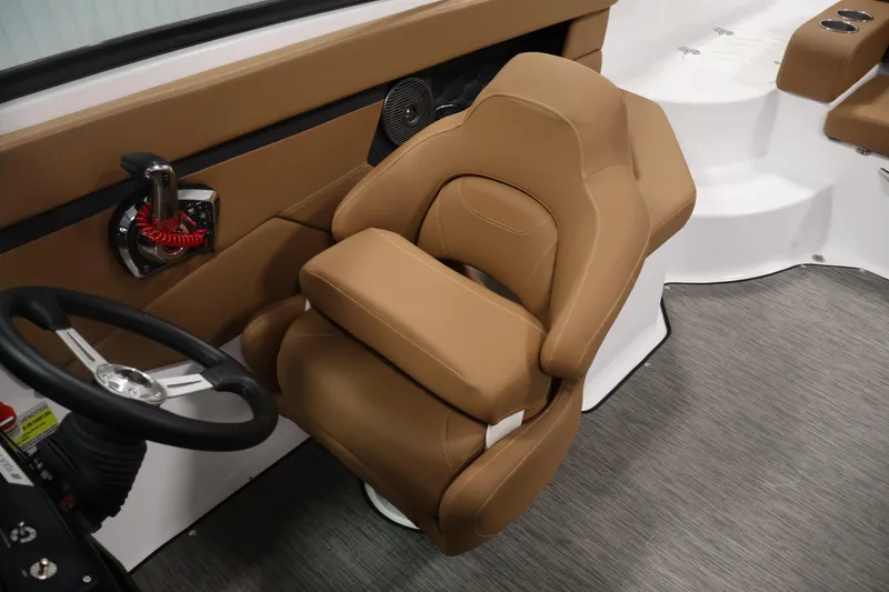 Slide: The Image of 2026 Four Winns HD2 OB boat interior with tan seating and steering wheel. - 28
