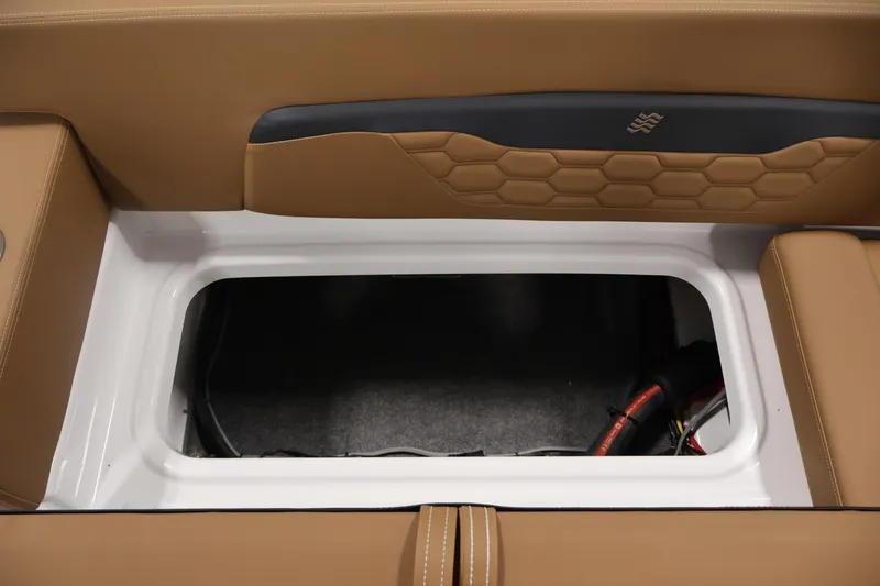 Slide: The Image of 2026 Four Winns HD2 OB boat storage compartment with tan upholstery and hexagonal pattern. - 36
