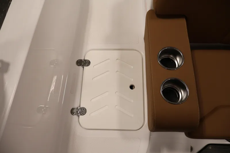 Slide: The Image of 2026 Four Winns HD2 OB boat interior with cup holders and storage compartment. - 39