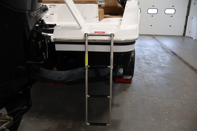 Slide: The Image of 2026 Four Winns HD2 OB boat with extended swim ladder in a garage setting. - 42
