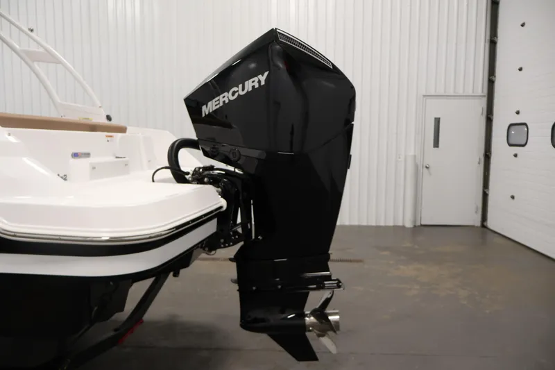Slide: The Image of 2026 Four Winns HD2 OB boat with Mercury outboard motor in a garage setting. - 43