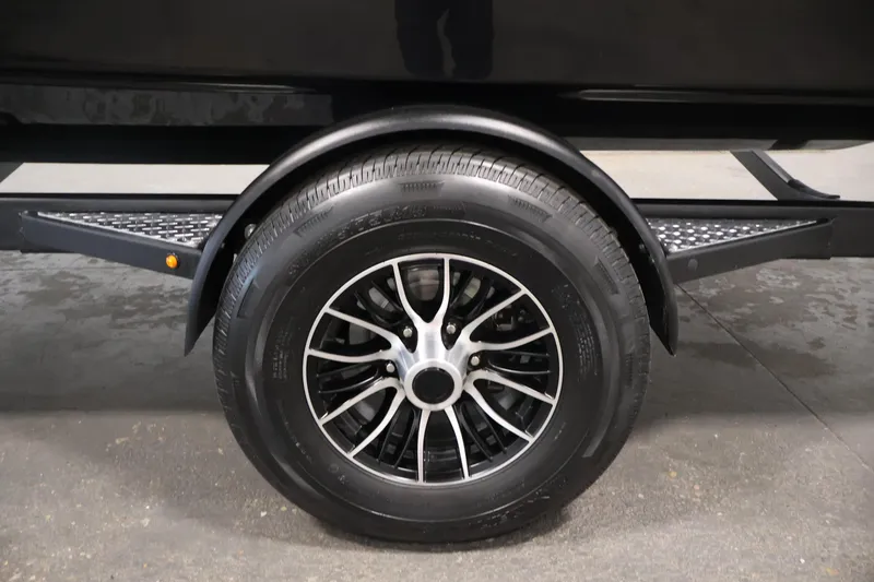 Slide: The Image of 2026 Four Winns HD2 OB trailer wheel with black alloy rim and tire. - 50