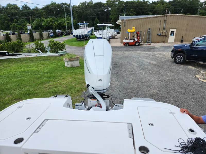 Slide: The Image of Rear view of a 2024 Caymas 28 HB boat with outboard motor. - 2