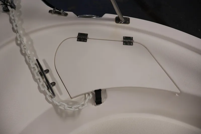 Slide: The Image of 2004 Trophy 2002 Walkaround boat anchor locker with chain and cleat. - 12