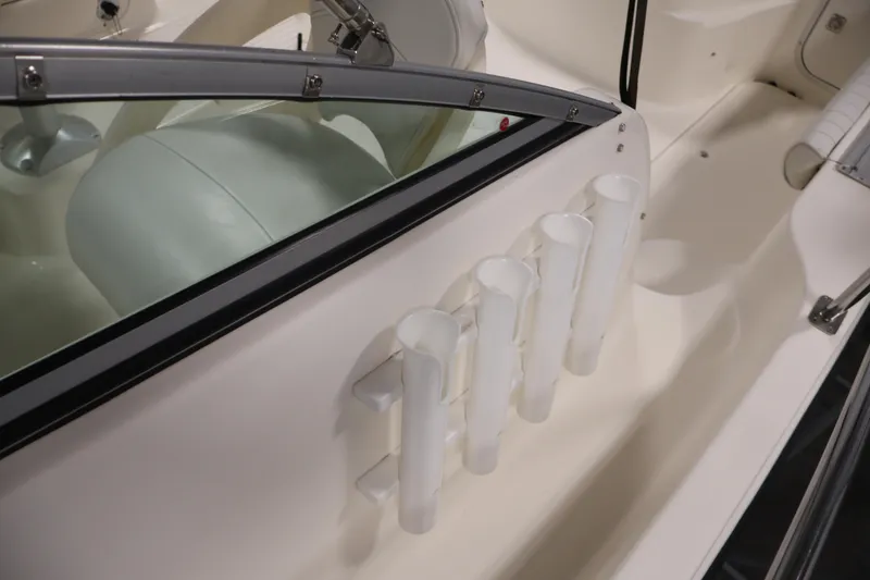 Slide: The Image of 2004 Trophy 2002 Walkaround boat interior with rod holders and seating. - 16