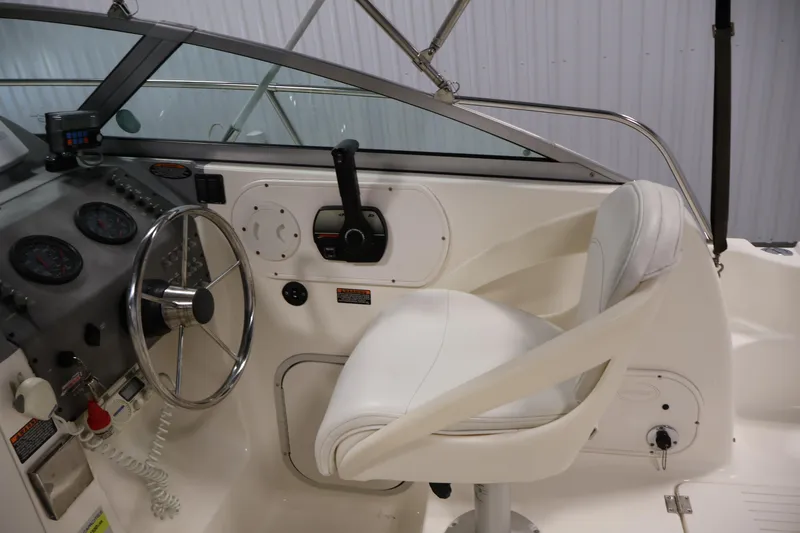 Slide: The Image of 2004 Trophy 2002 Walkaround boat cockpit with steering wheel and controls. - 18