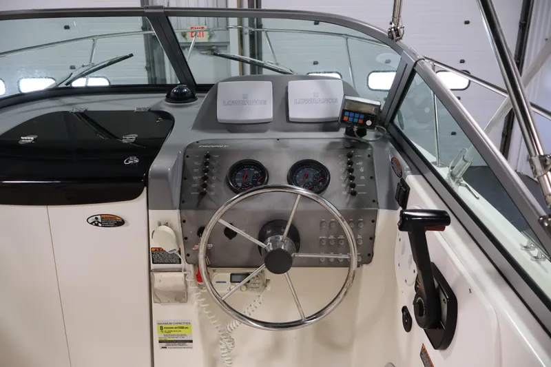 Slide: The Image of 2004 Trophy 2002 Walkaround boat dashboard with steering wheel and navigation instruments. - 19